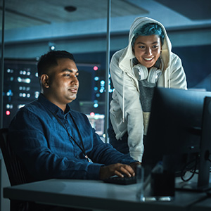 cyber security professionals looking at computer screen